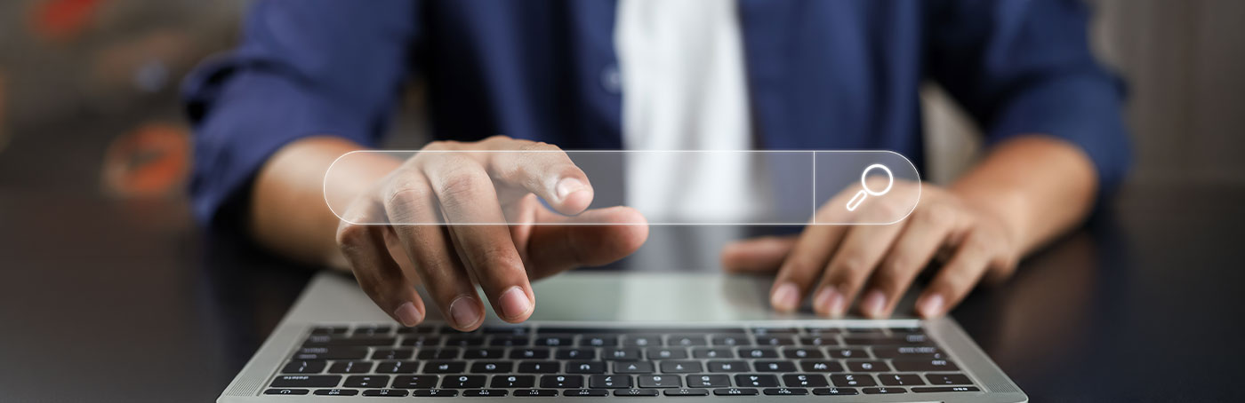A woman clicking onto a search bar graphic, overlayed on the image